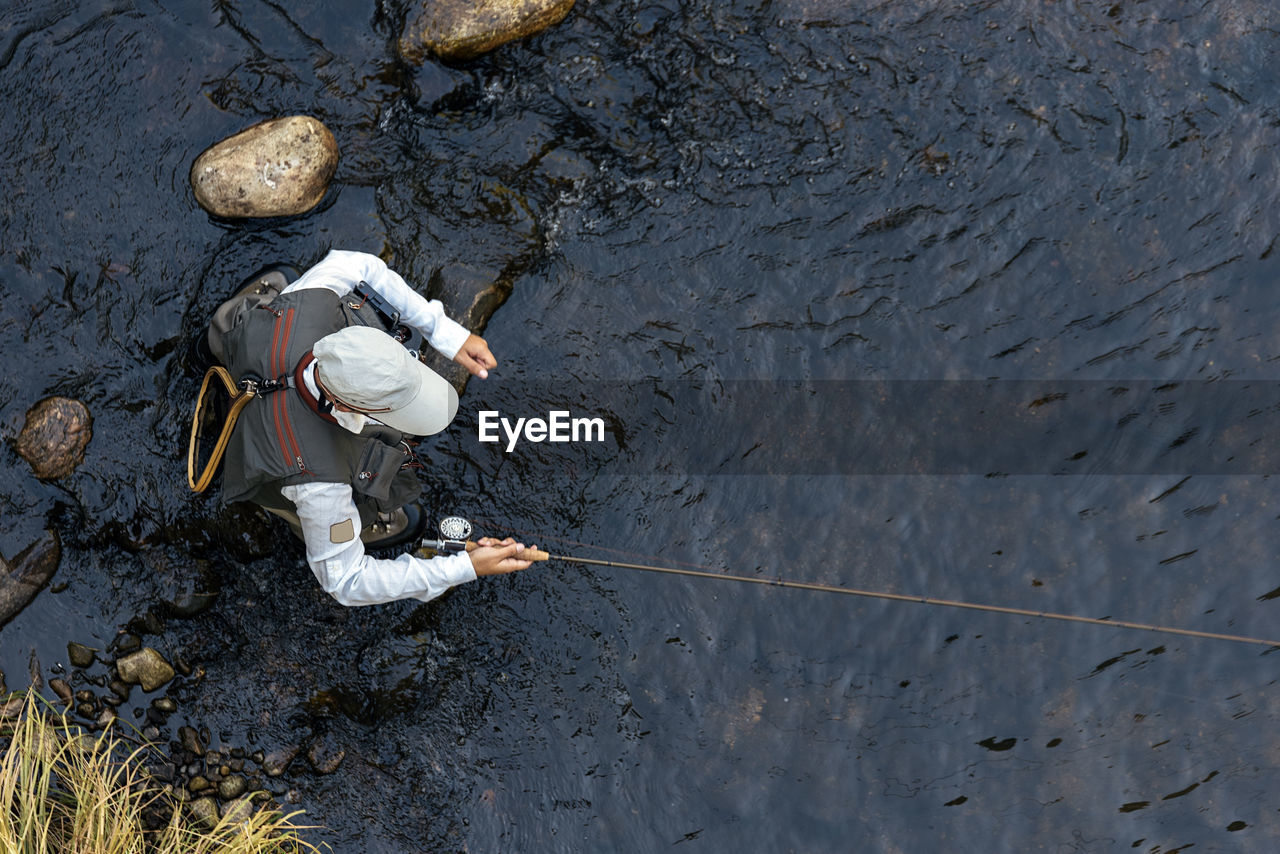 High angle view of person working on riverbank