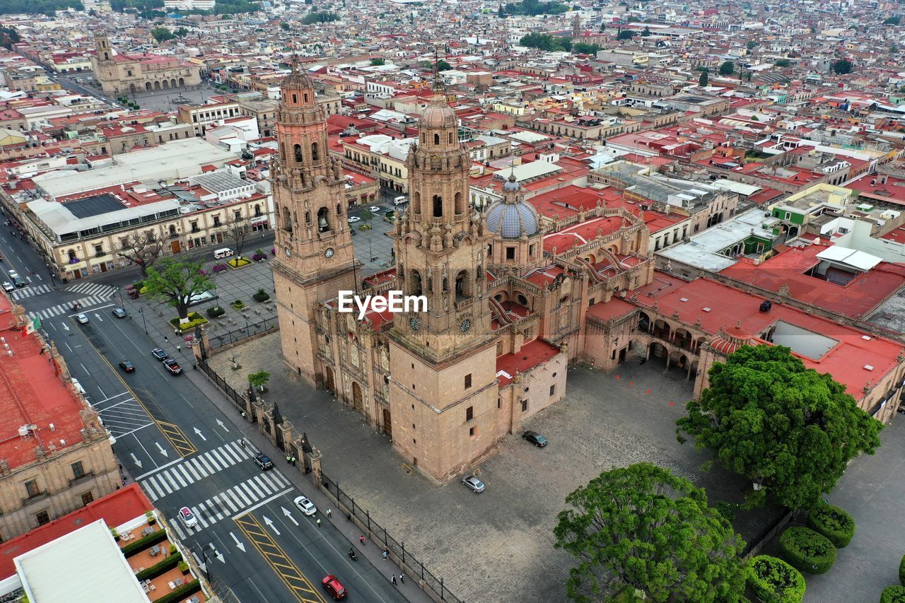 HIGH ANGLE VIEW OF CITY STREET AMIDST BUILDINGS IN BACKGROUND