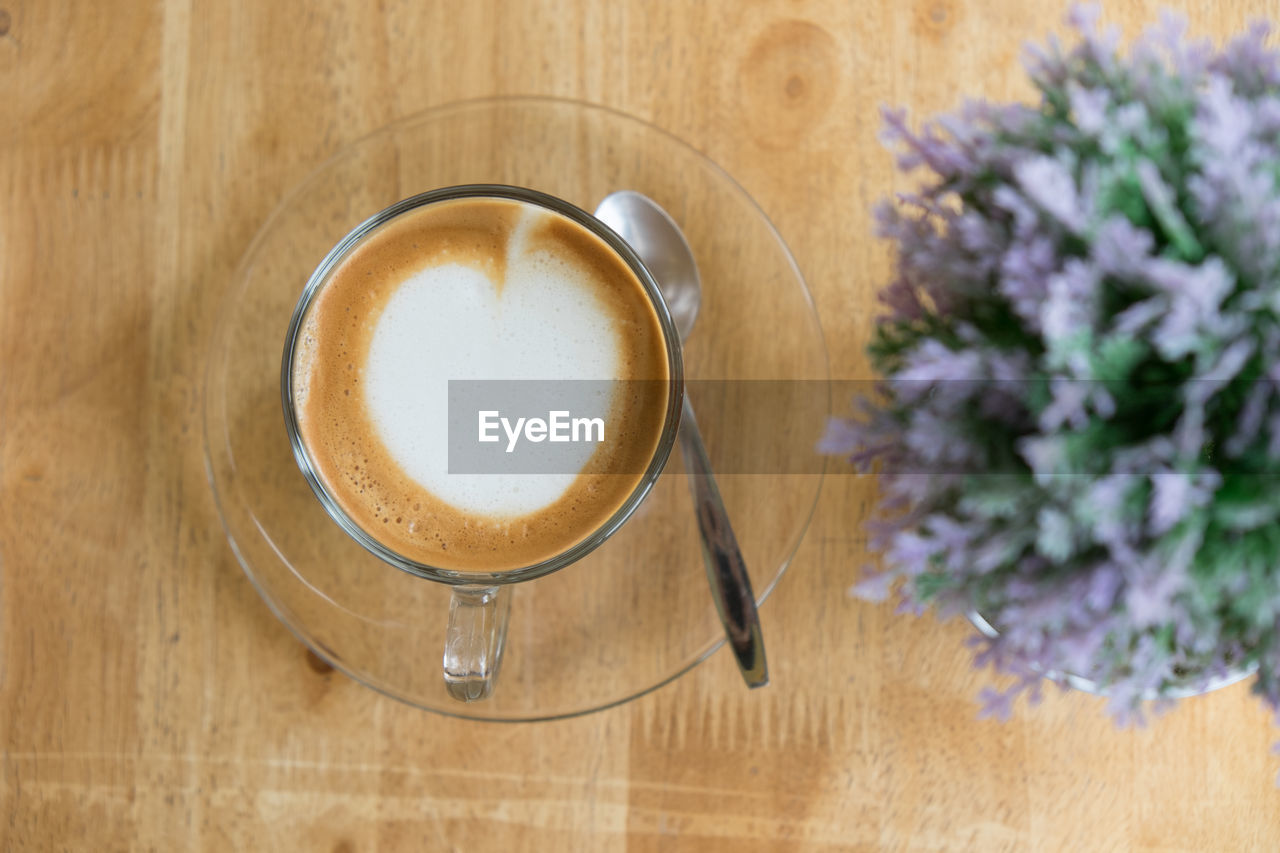 DIRECTLY ABOVE SHOT OF COFFEE ON TABLE AGAINST WALL