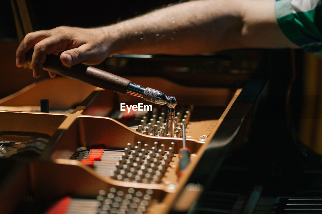 Cropped image of hand working on piano