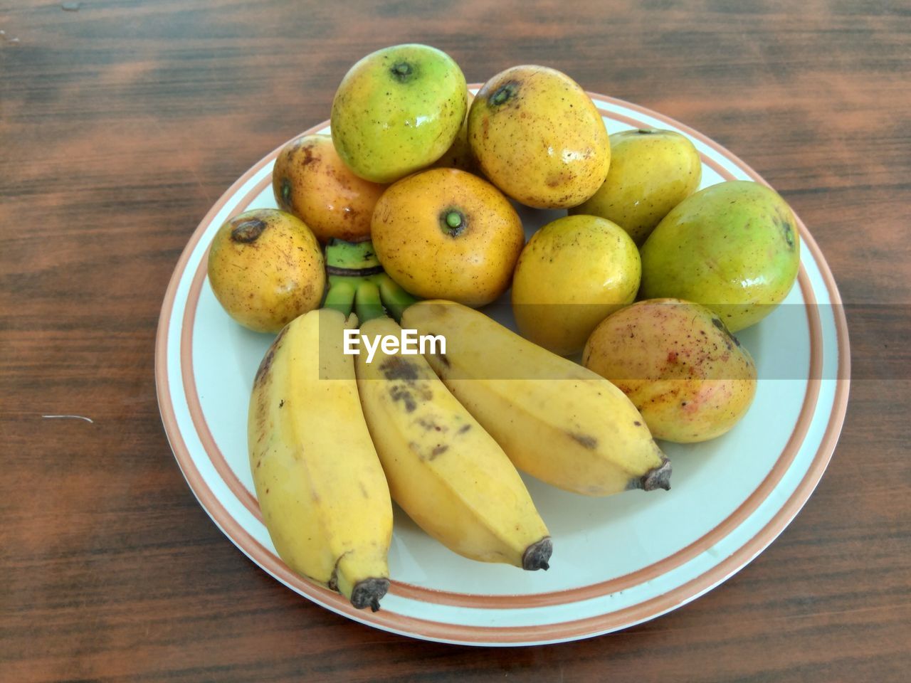 High angle view of various fruits in plate on table