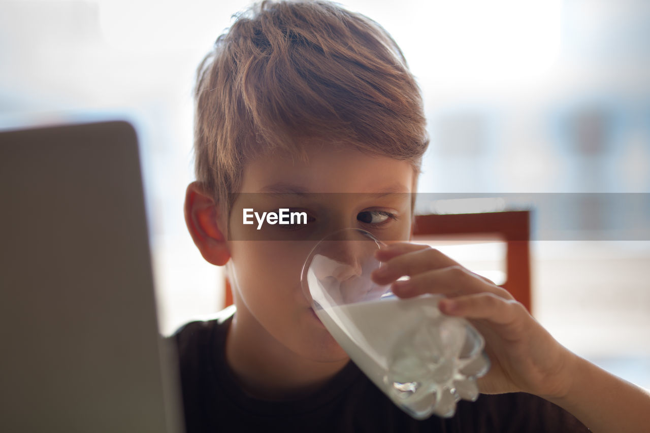 Boy drinking milk at home