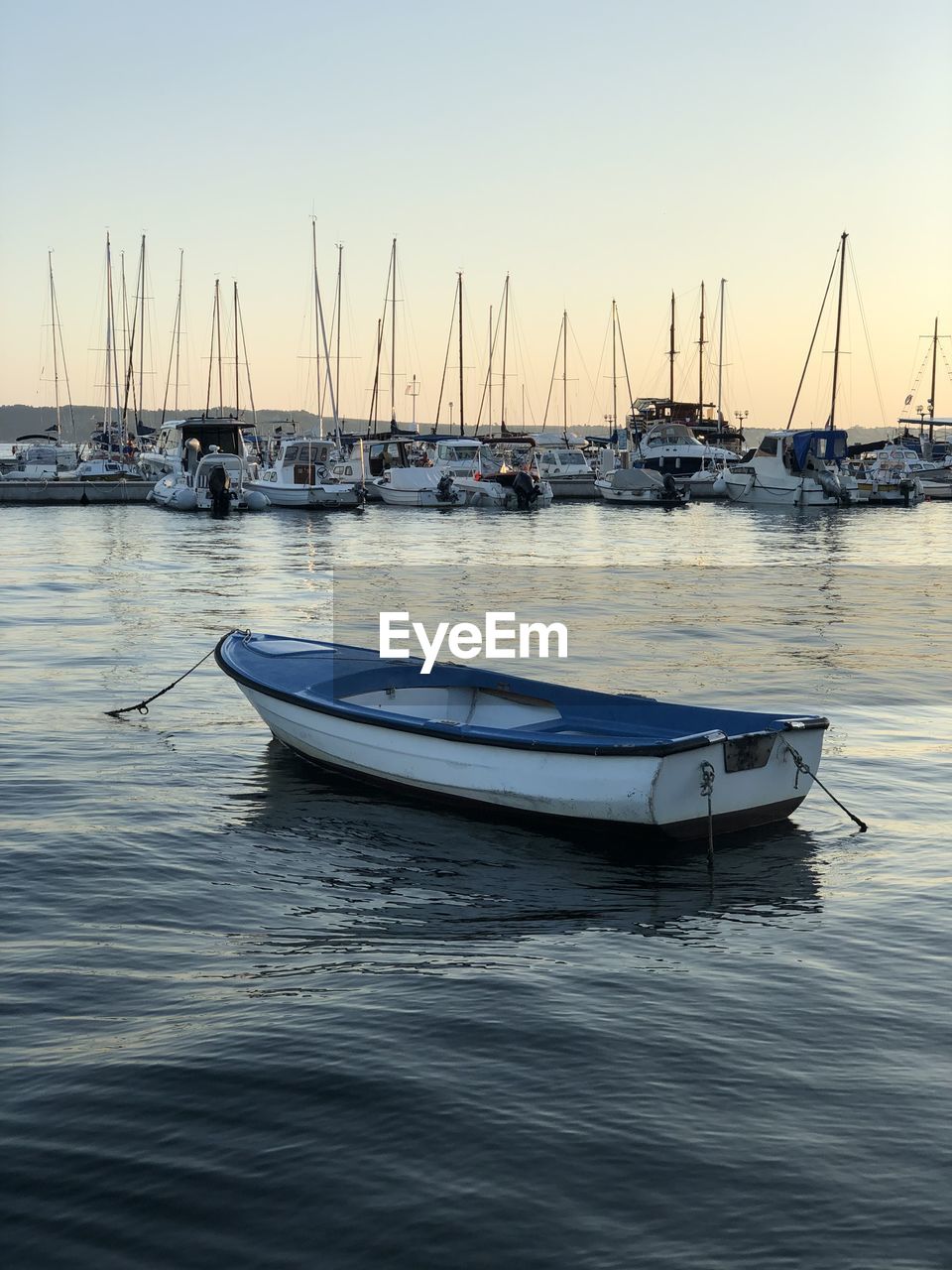 SAILBOATS MOORED AT MARINA