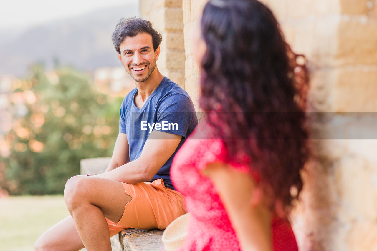 side view of woman sitting on field