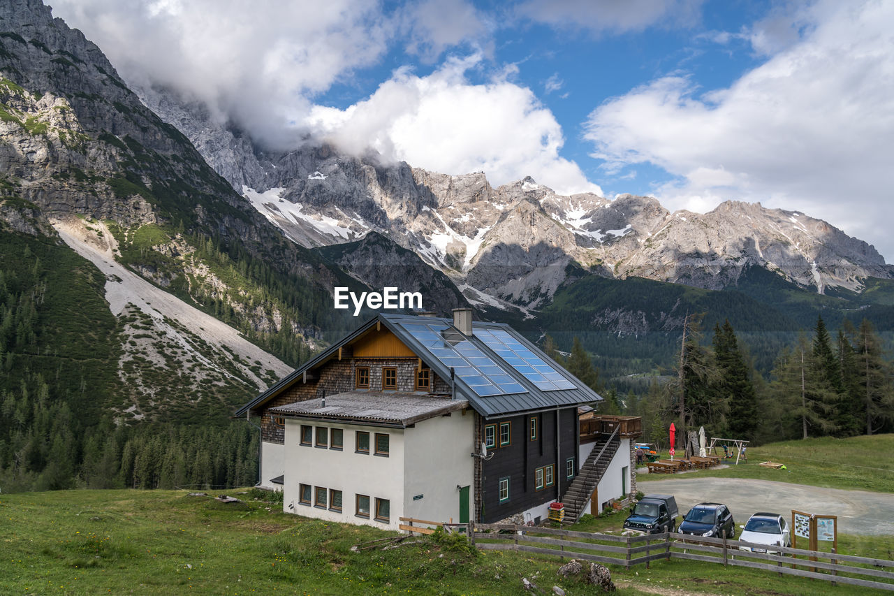 HOUSES ON MOUNTAIN AGAINST SKY