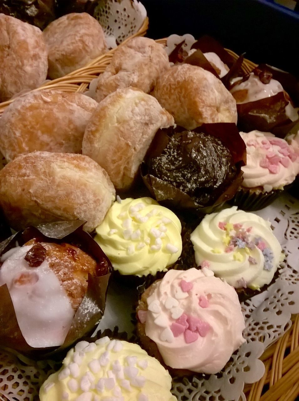 High angle view of cupcakes and breads in basket