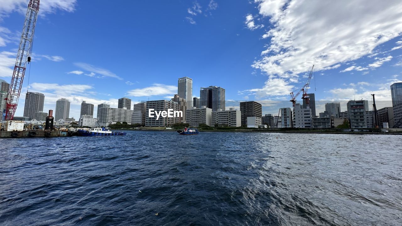 city, architecture, built structure, building exterior, building, sky, office building exterior, skyscraper, skyline, landscape, urban skyline, horizon, cityscape, water, downtown district, nature, travel destinations, residential district, waterfront, cloud, office, city life, blue, downtown, travel, urban area, no people, transportation, sea, outdoors, harbor, landmark, business, nautical vessel, financial district, reflection, tower block, day, tourism, ship, development