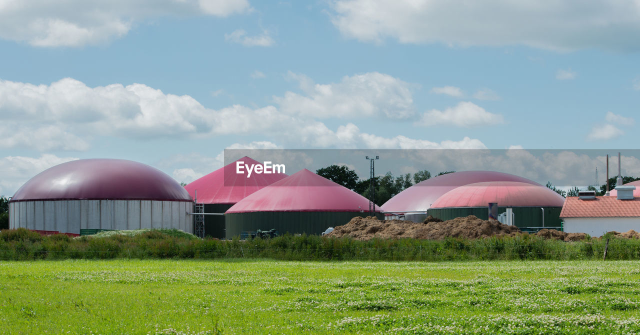 BUILT STRUCTURES ON FIELD AGAINST SKY