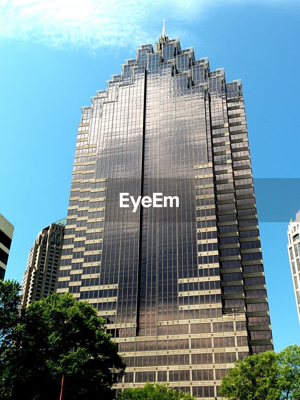 Low angle view of modern building against blue sky