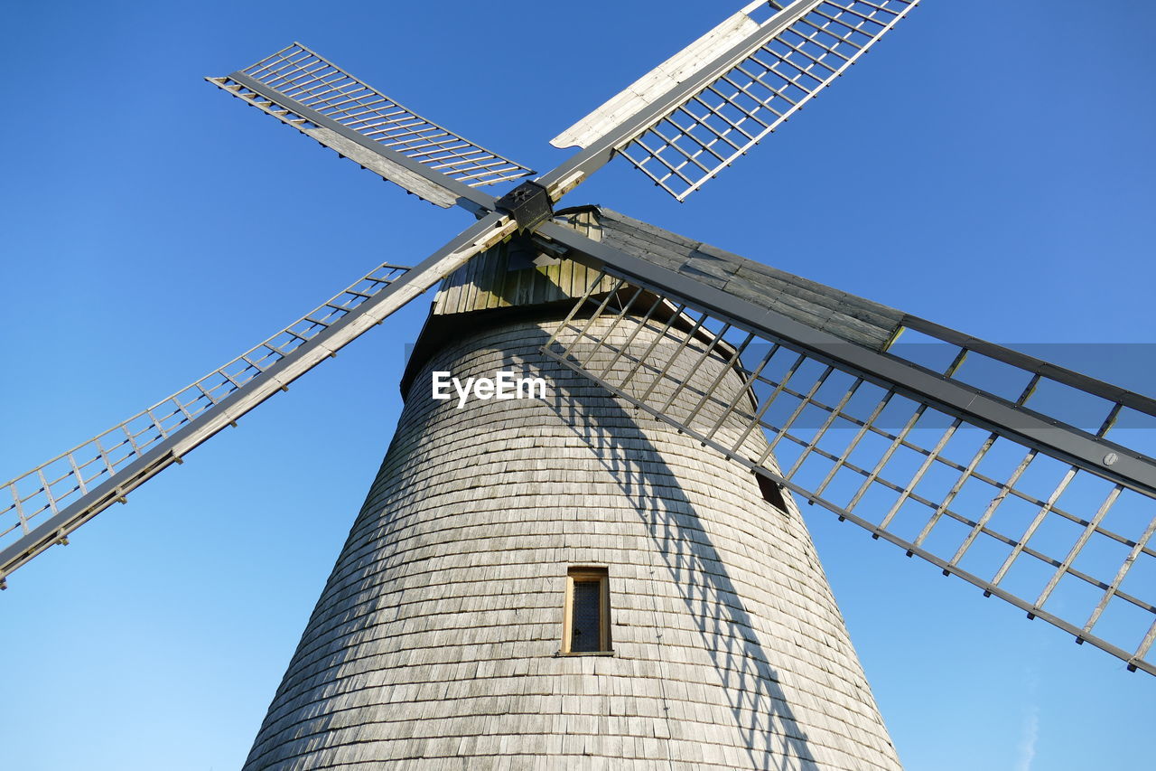 Historical windmill against blue sky 