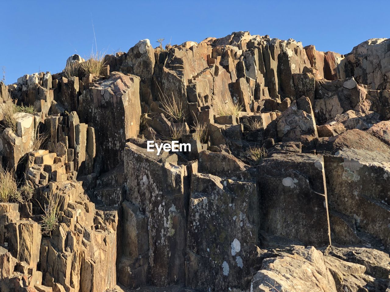LOW ANGLE VIEW OF ROCK FORMATION AGAINST SKY