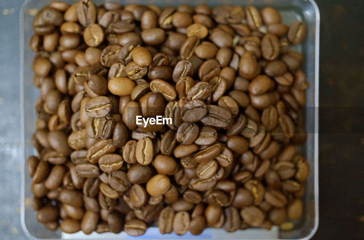 HIGH ANGLE VIEW OF COFFEE BEANS IN GLASS