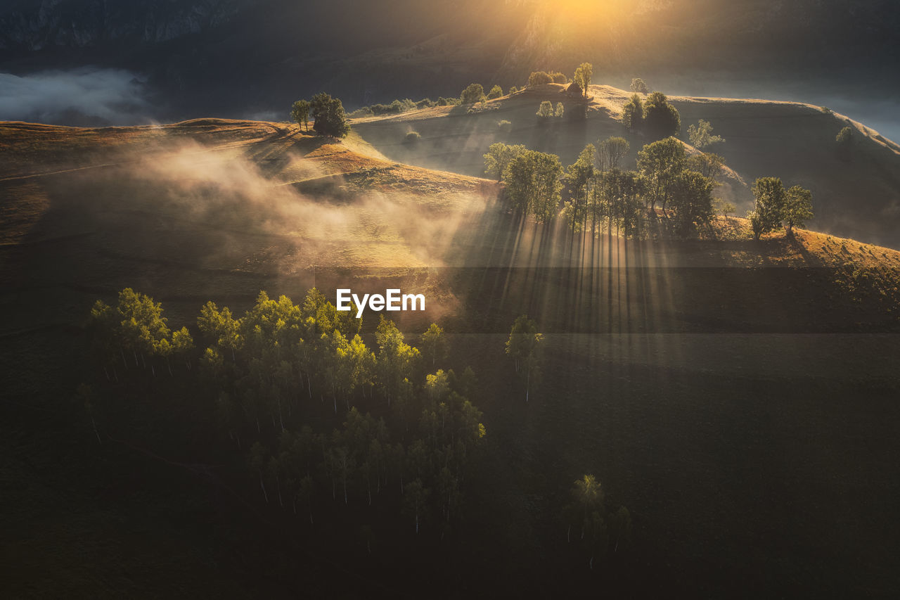 View from drone of incredible atmosphere with foggy hills at sunrise. 