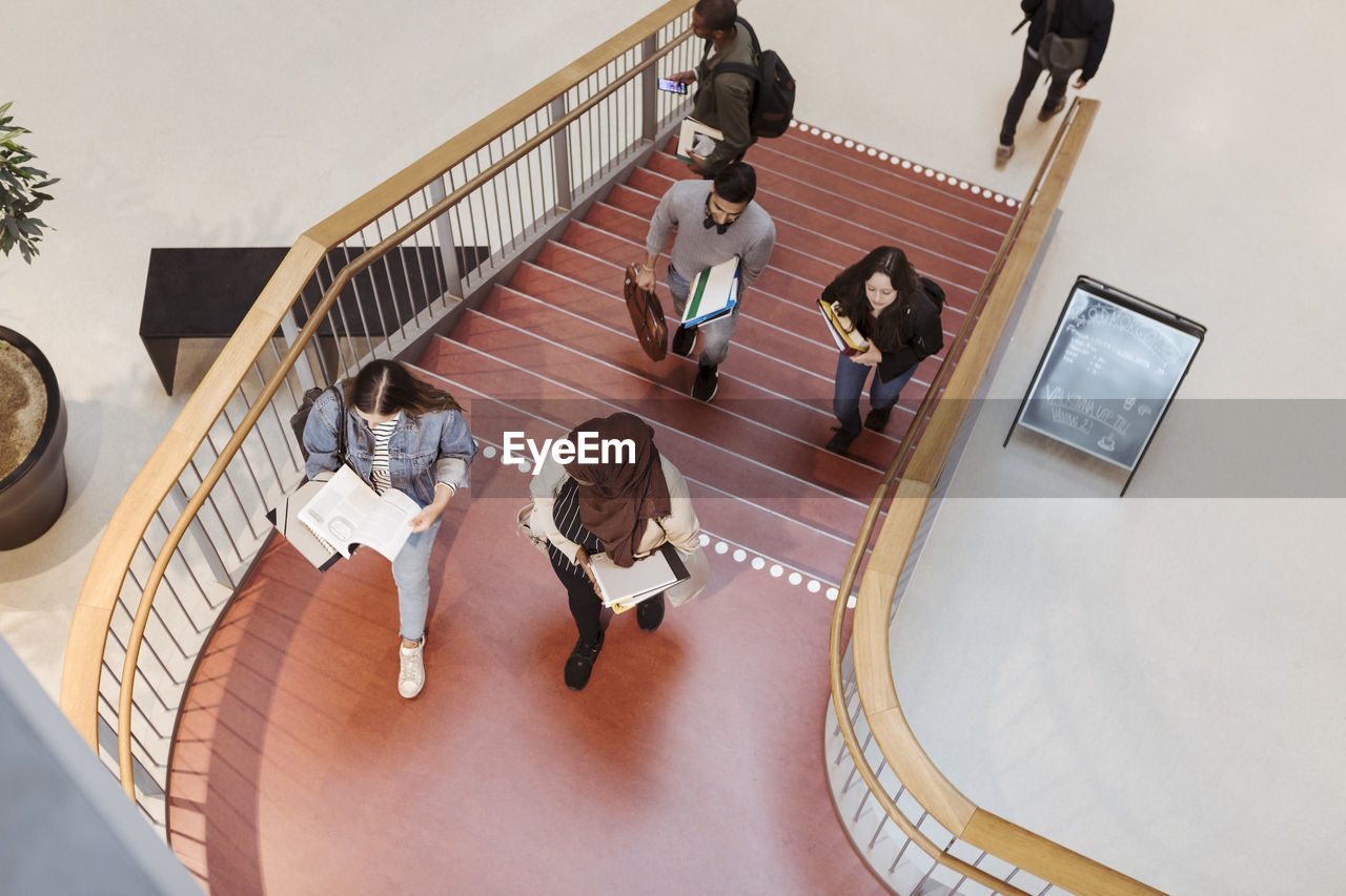 High angle view of students walking on steps in university