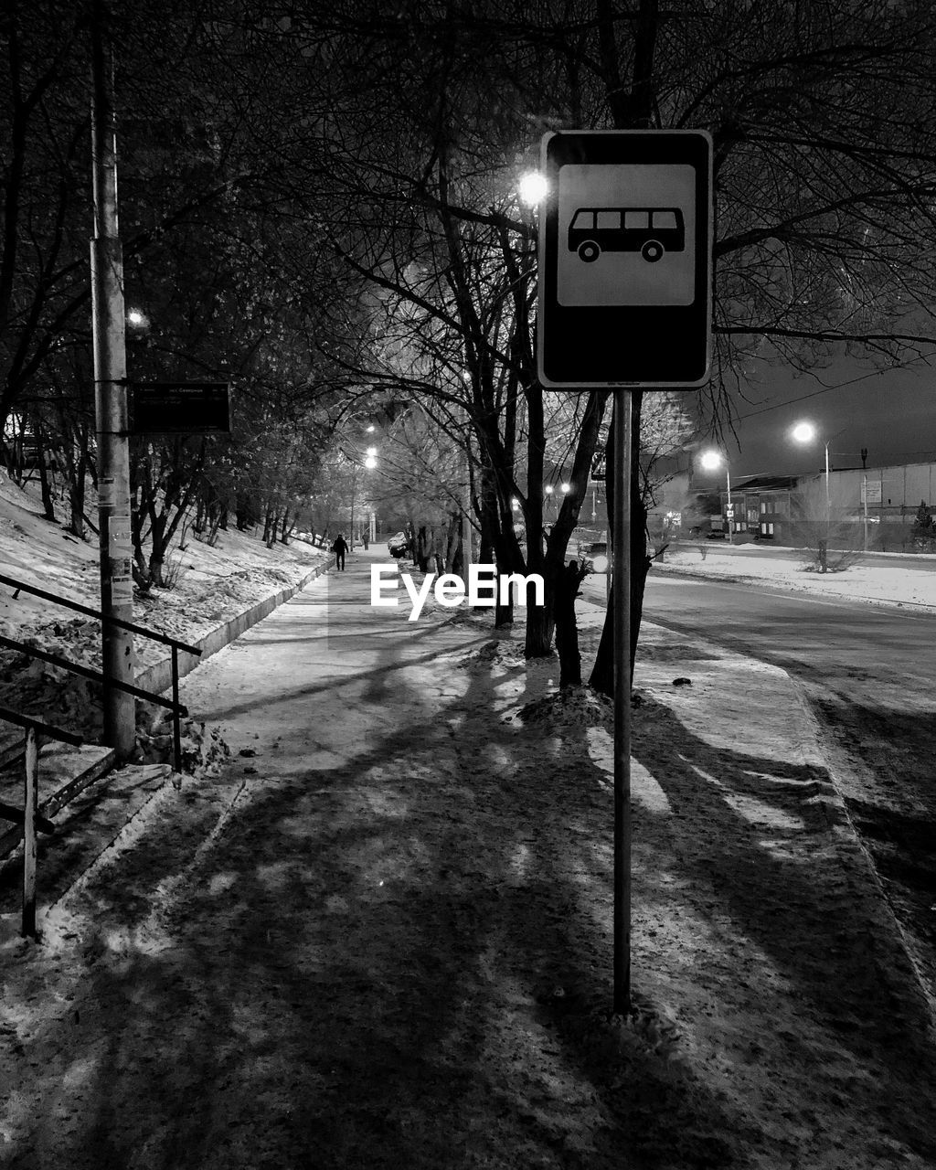 ILLUMINATED STREET LIGHT ON SNOW COVERED ROAD