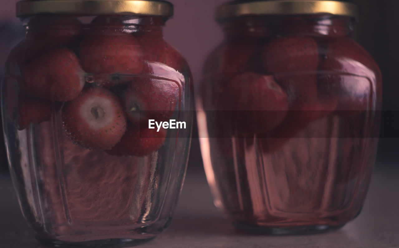 Close-up of fruits in glass jar on table