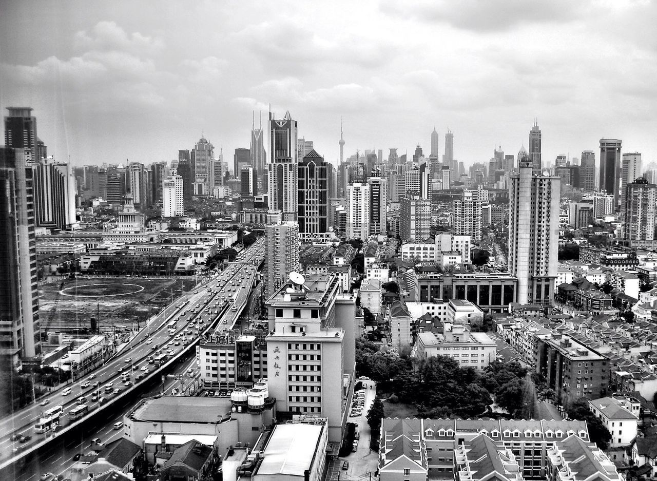 High angle shot of vehicles on road along cityscape