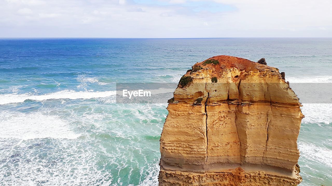 VIEW OF ROCK FORMATION ON SEA AGAINST SKY