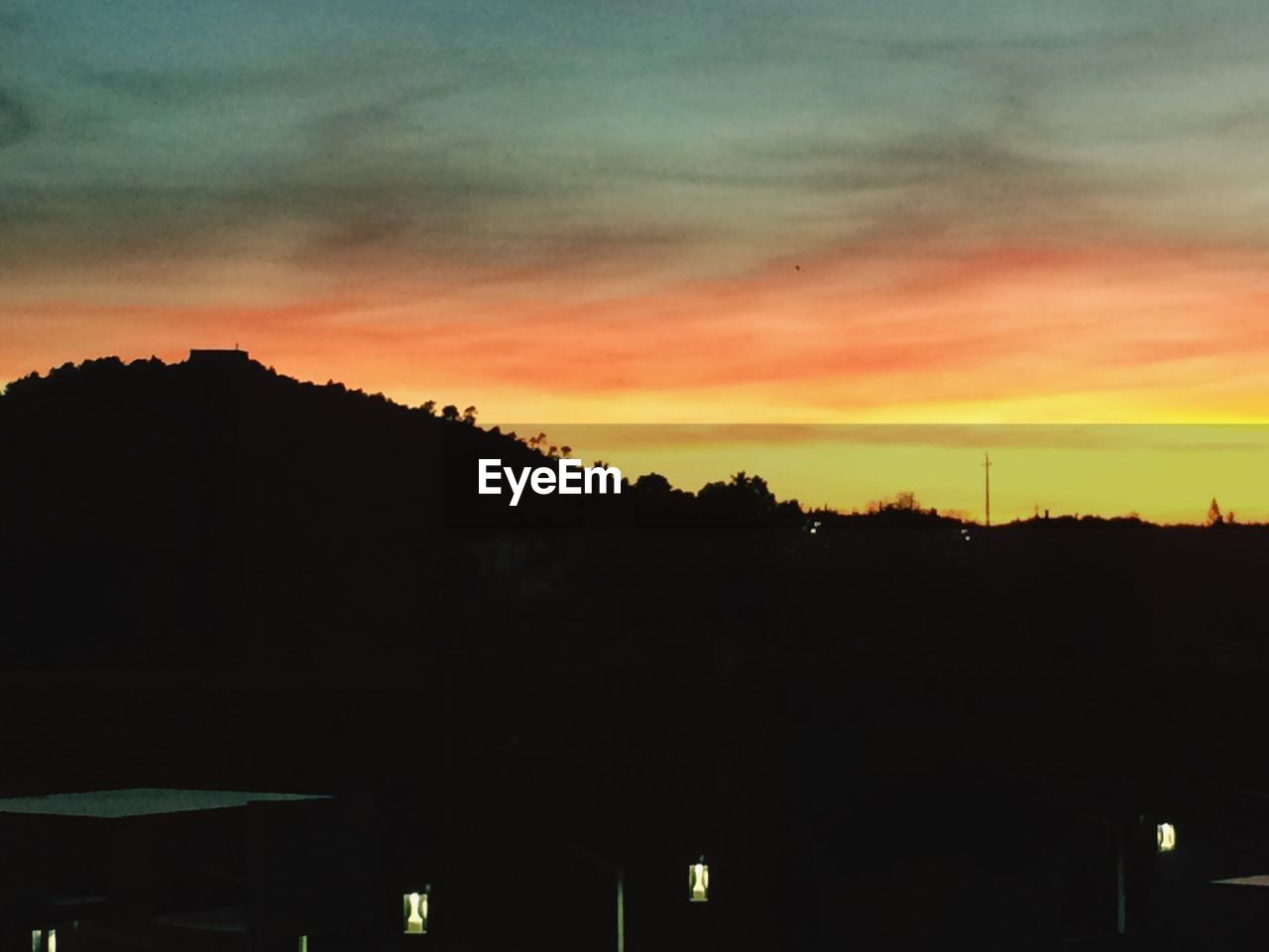 SCENIC VIEW OF SILHOUETTE TREES AGAINST ORANGE SKY