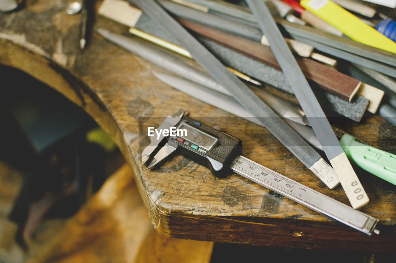 High angle view of digital caliper on workbench in jewelry workshop