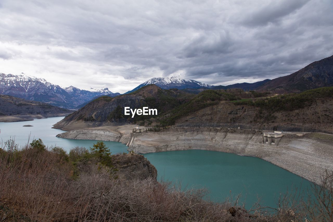 Scenic view of lake and mountains against sky