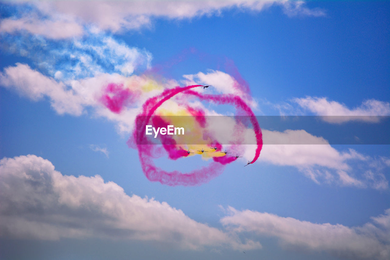 LOW ANGLE VIEW OF PINK KITE FLYING AGAINST SKY