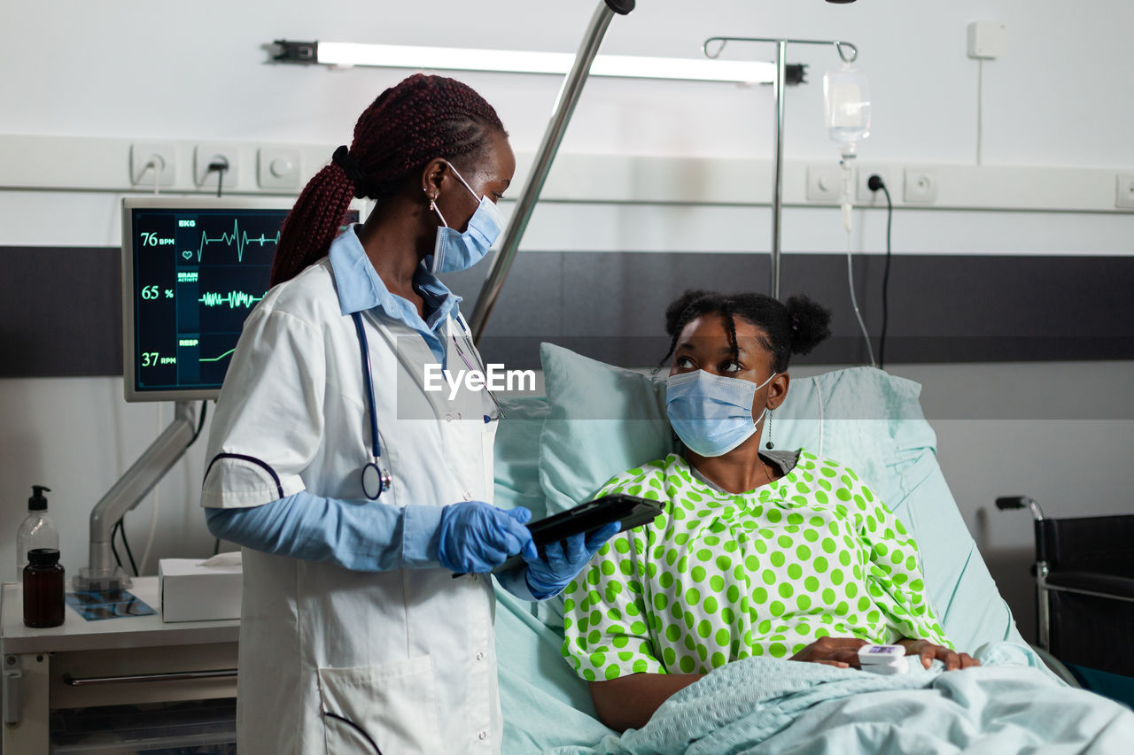 female doctor giving medicine in hospital