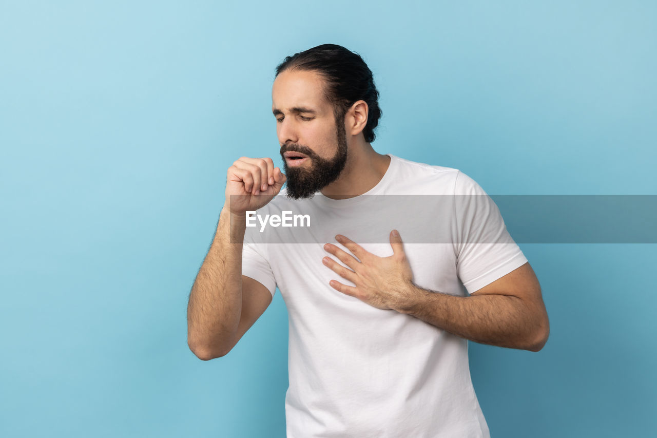 side view of young man using mobile phone