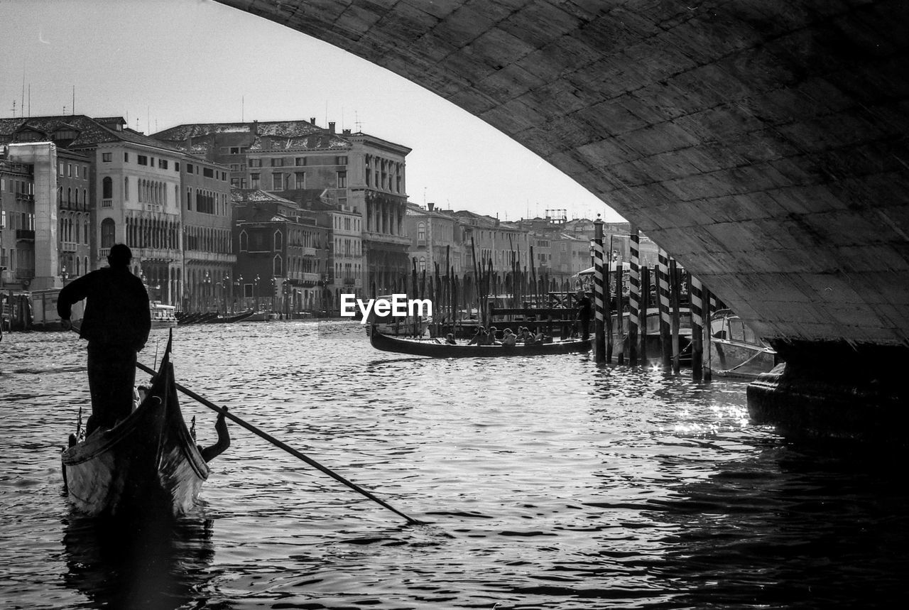 Man sailing gondola on canal