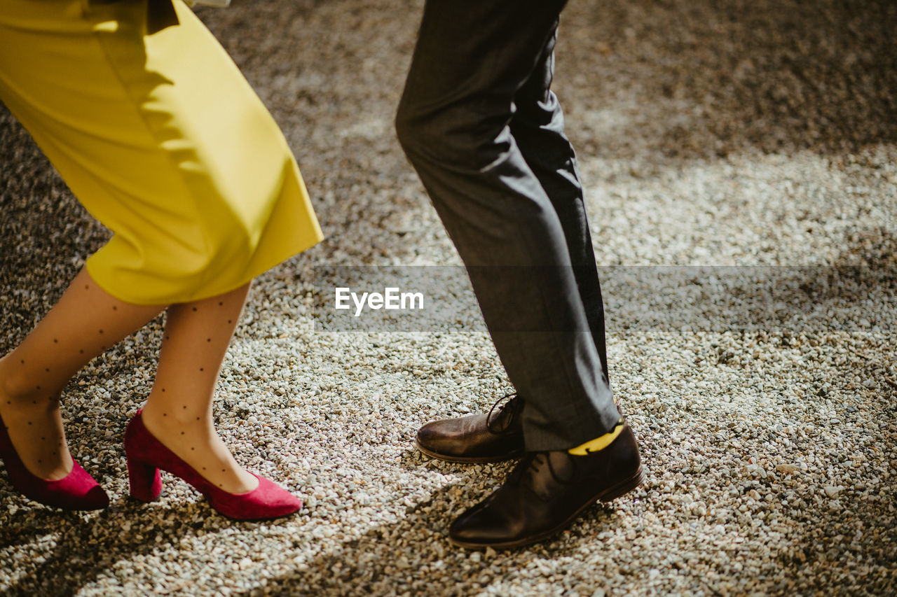 Low section of couple dancing on rug at party