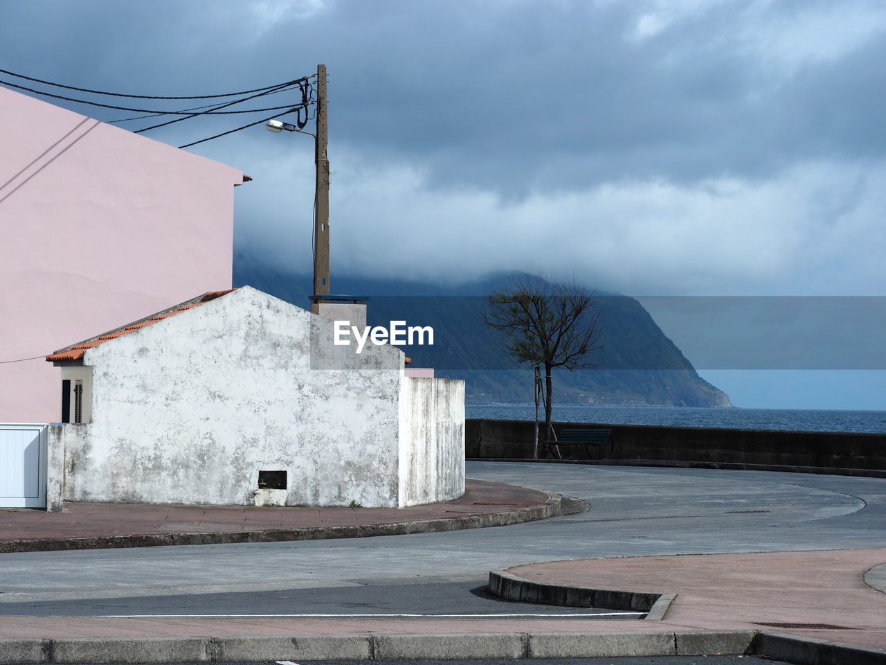 Built structure by mountain against sky