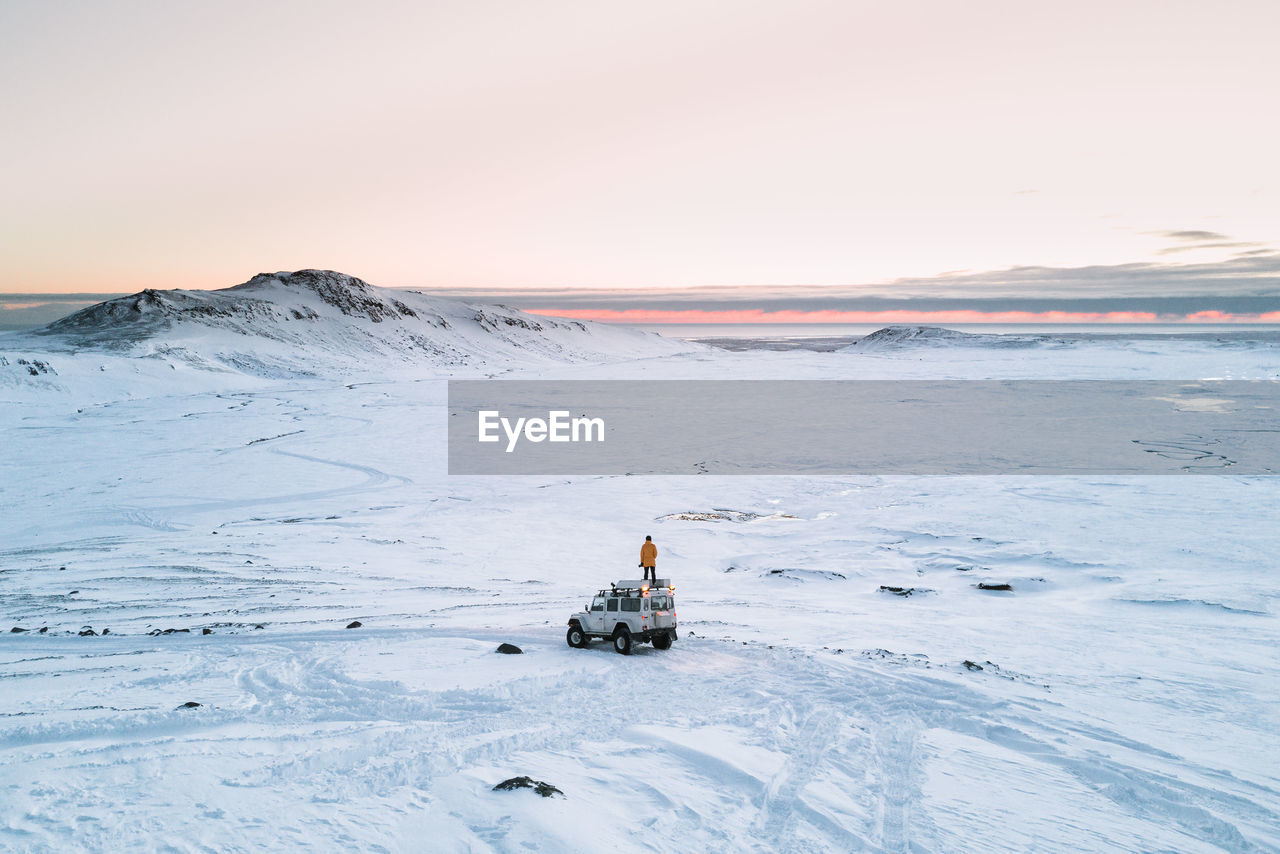 Person on vehicle at snow covered landscape