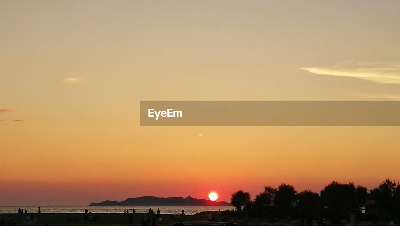 Scenic view of silhouette trees against orange sky