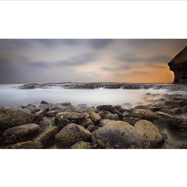 SCENIC VIEW OF ROCKS AT BEACH