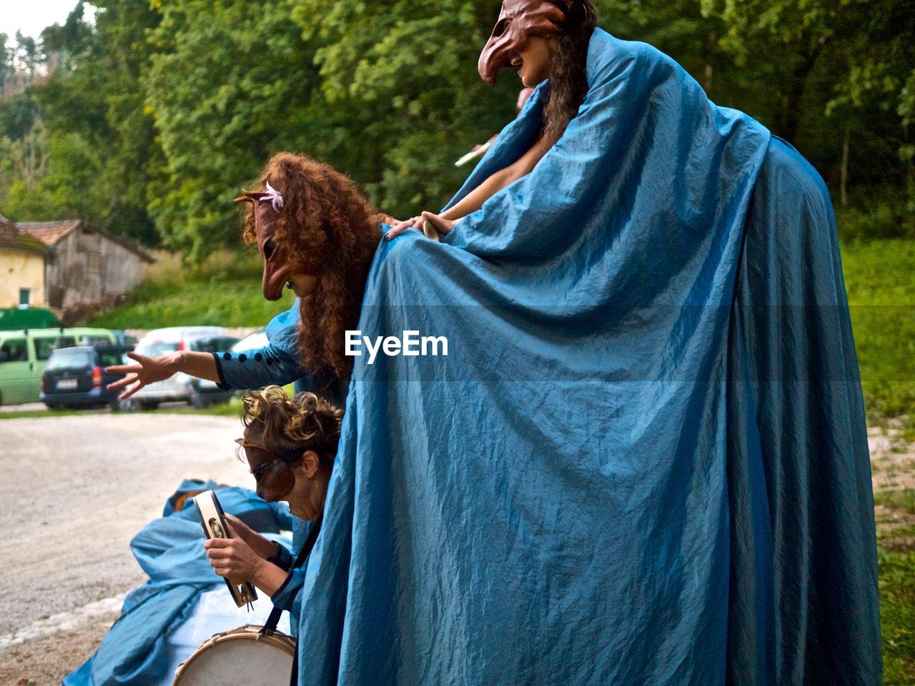 REAR VIEW OF PEOPLE SITTING ON SWING