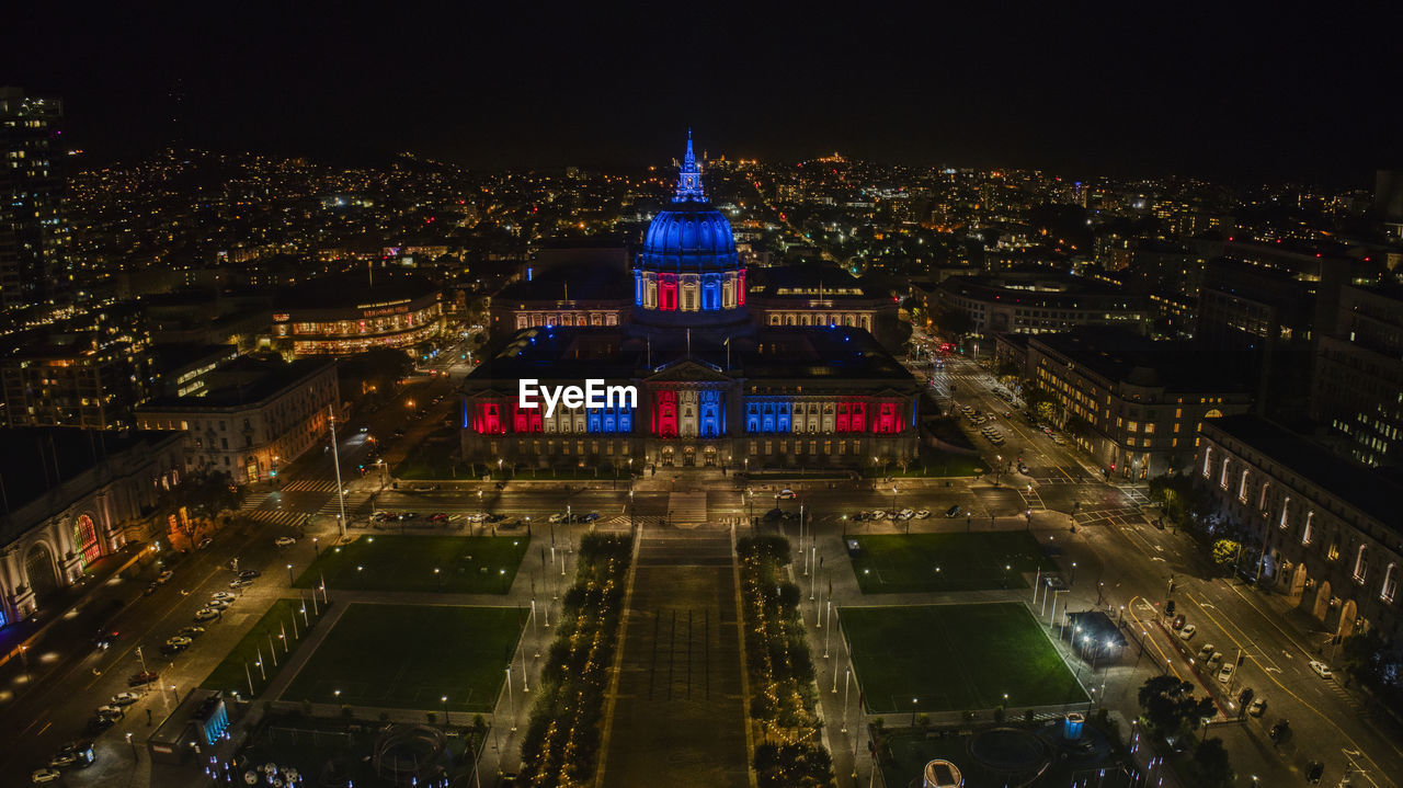 HIGH ANGLE VIEW OF ILLUMINATED CITY BUILDINGS