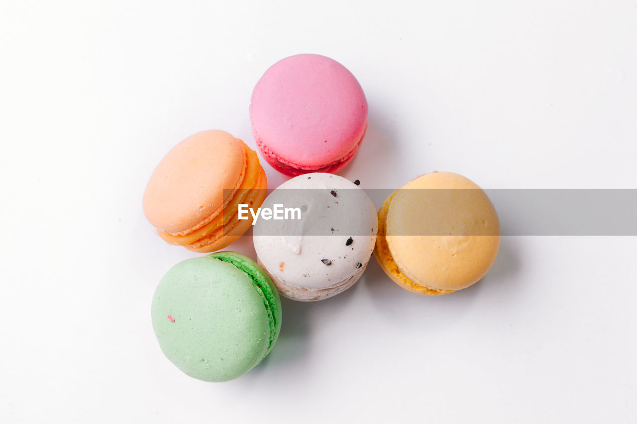 Close-up of macaroons over white background