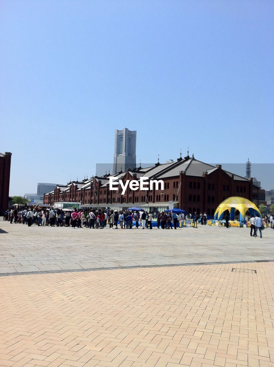 PEOPLE IN FRONT OF BUILDINGS AGAINST CLEAR SKY