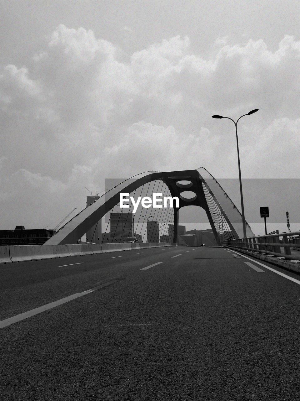 BRIDGE OVER STREET AGAINST SKY