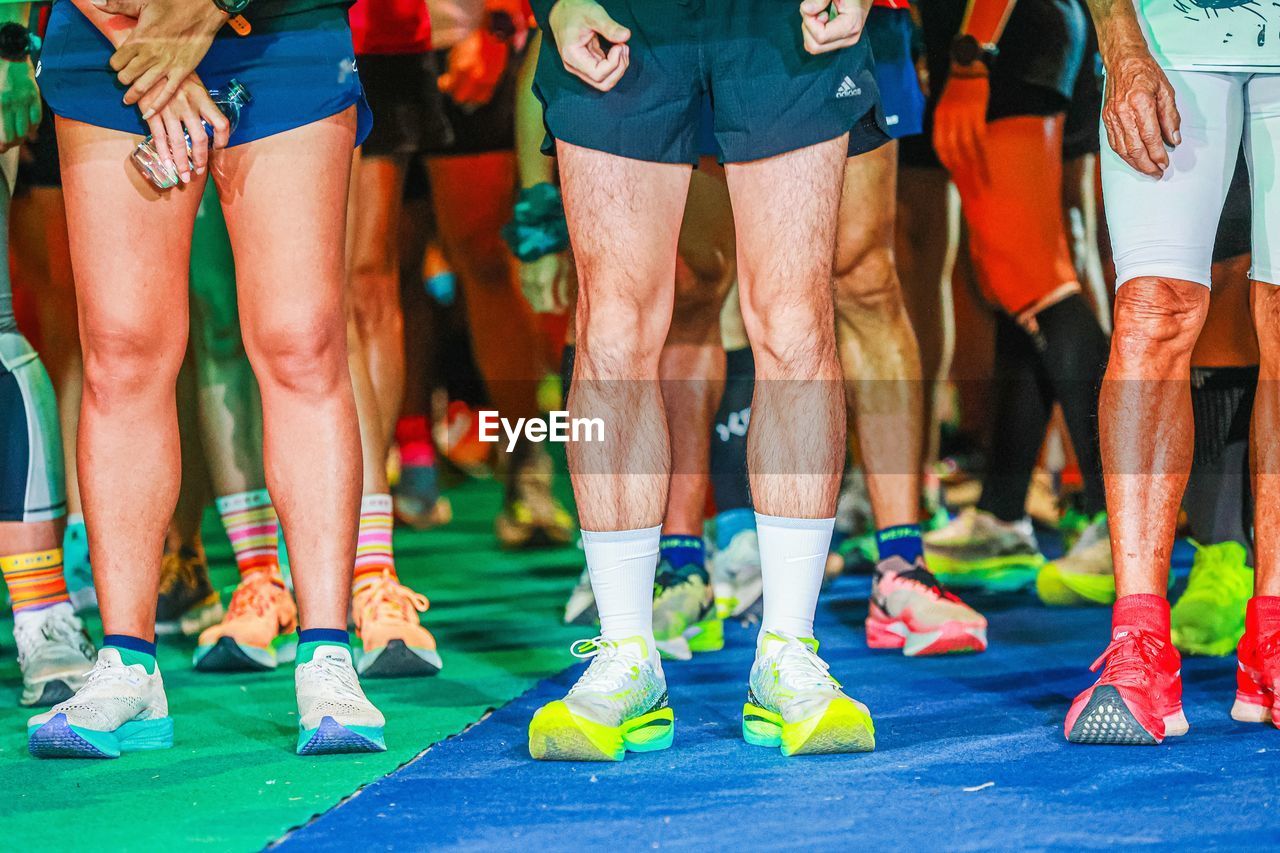 sports, group of people, track and field event, endurance sports, adult, sprinting, lifestyles, athlete, clothing, human leg, exercising, low section, footwear, men, sports clothing, swimming, women, limb, day, shoe, recreation, running, competition, leisure activity, human limb, multi colored, outdoors, crowd, relaxation, event