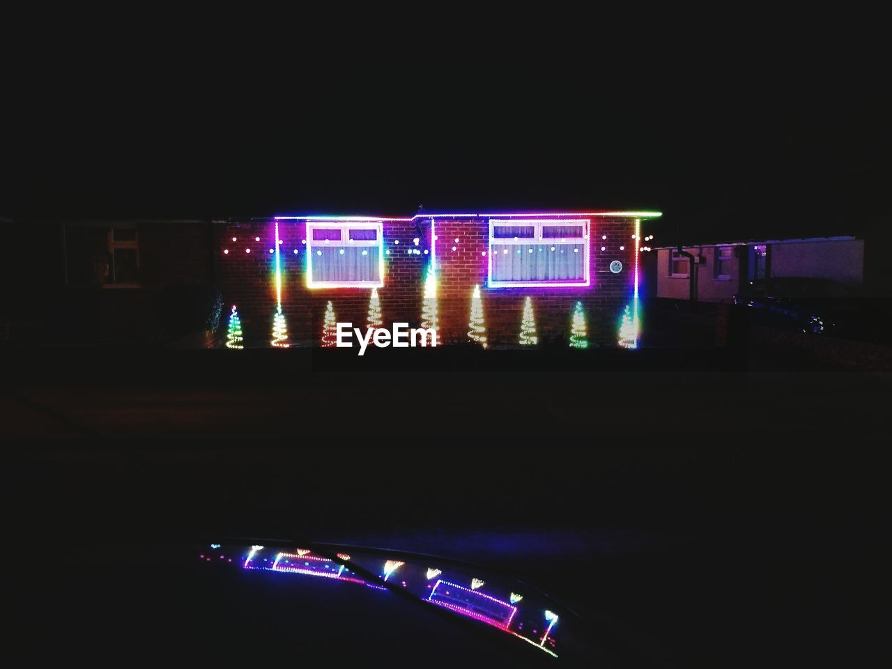 VIEW OF ILLUMINATED BUILDING AT NIGHT