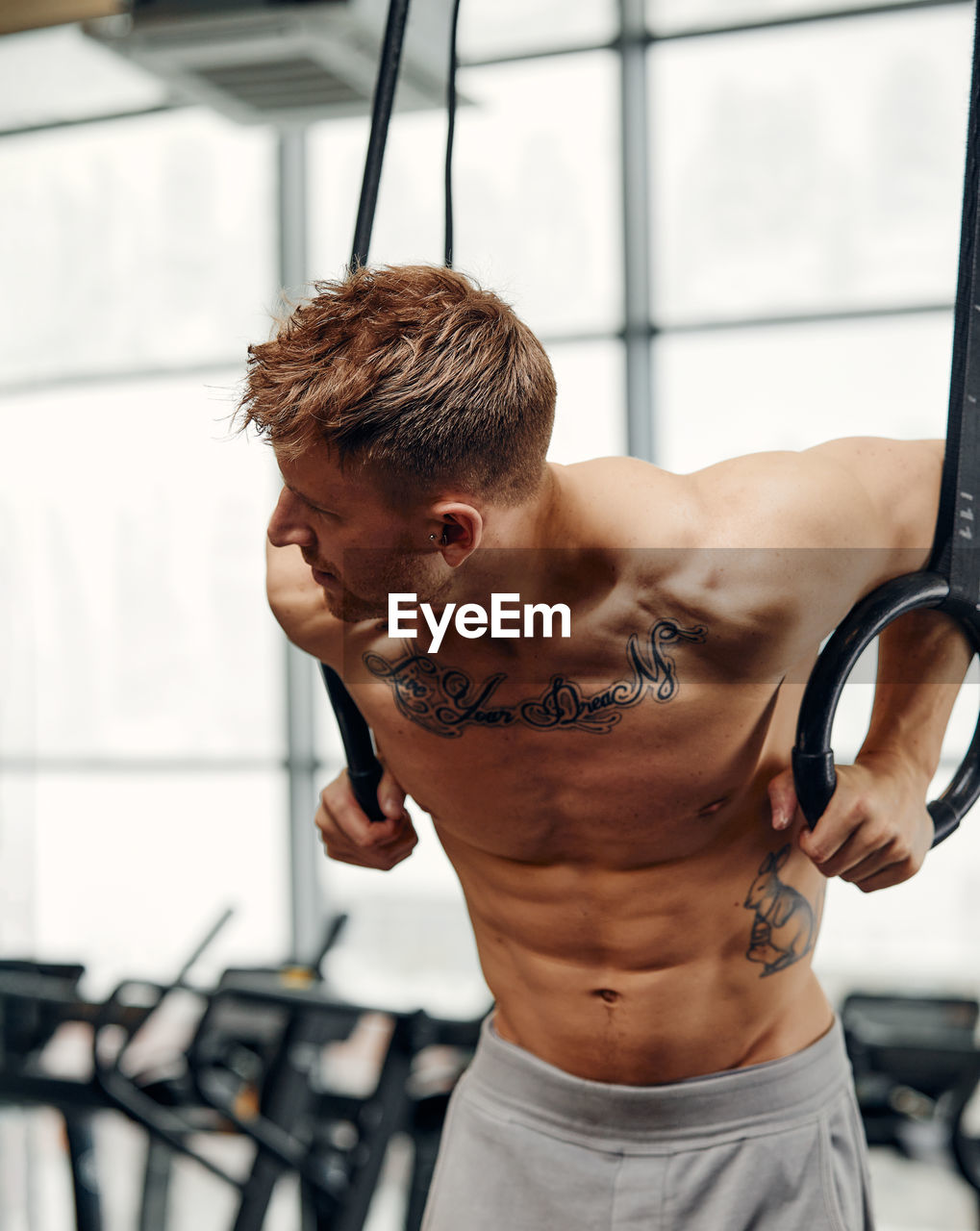 side view of young man exercising in gym