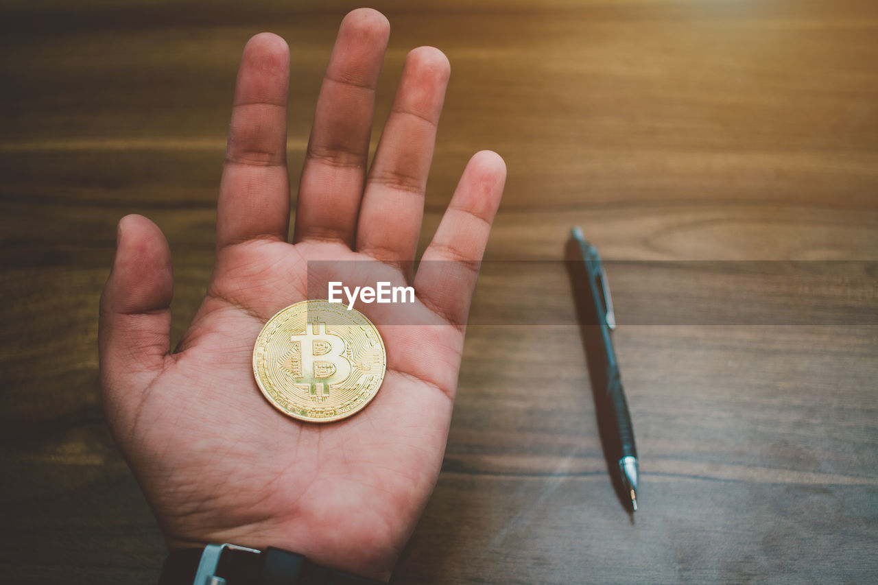 Close-up of hand holding bit coin