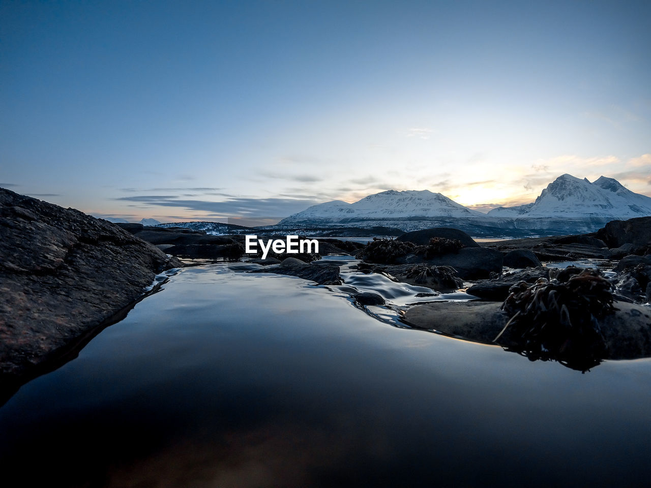 Scenic view of lake and mountains against sky