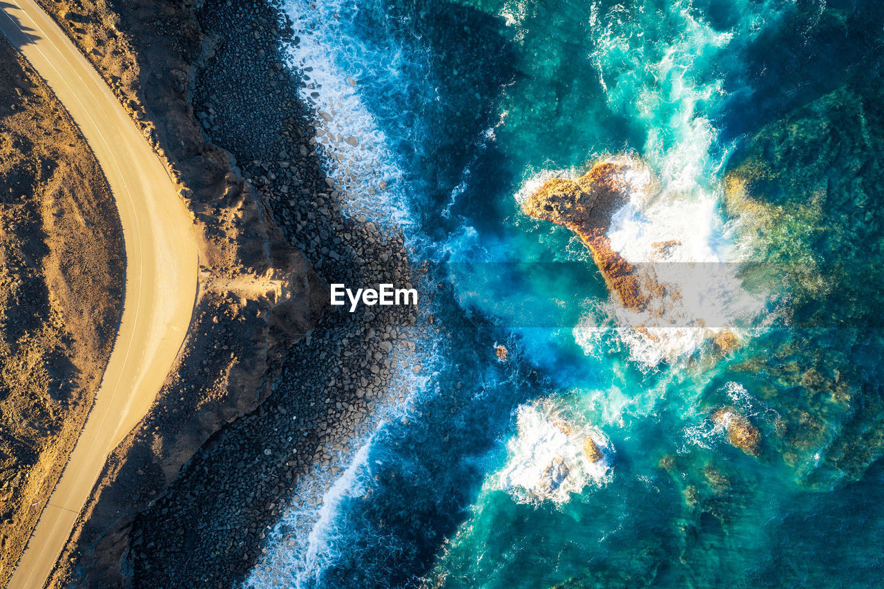 High angle view of rippled water on rock