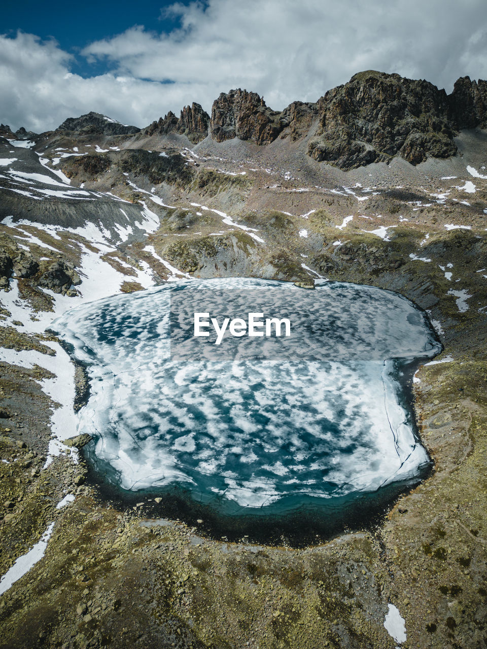 Aerial image of frozen tscheppa lake or lej da la tscheppa above silvaplana, engadin, switzerland