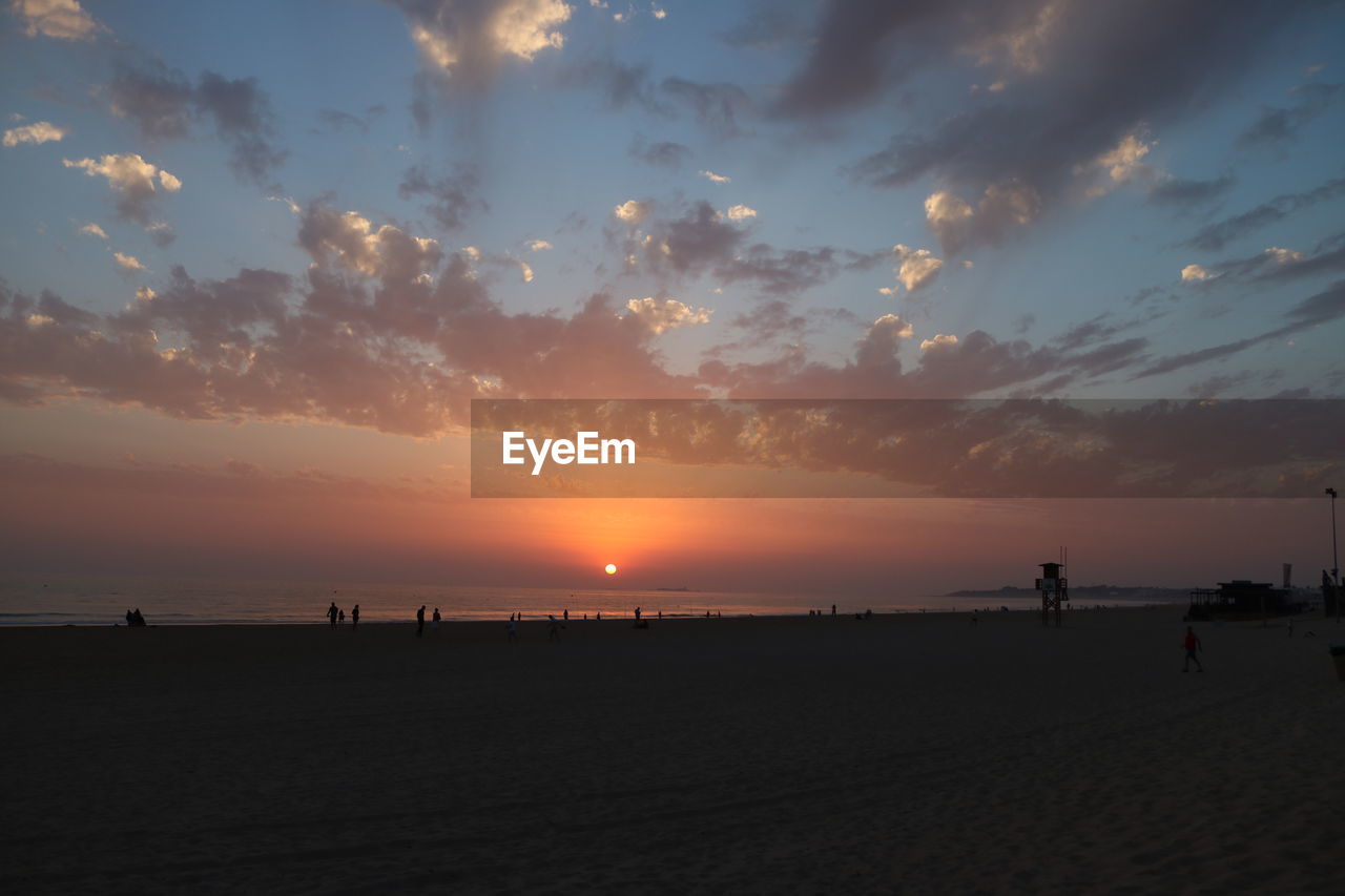 SCENIC VIEW OF SUNSET OVER SEA