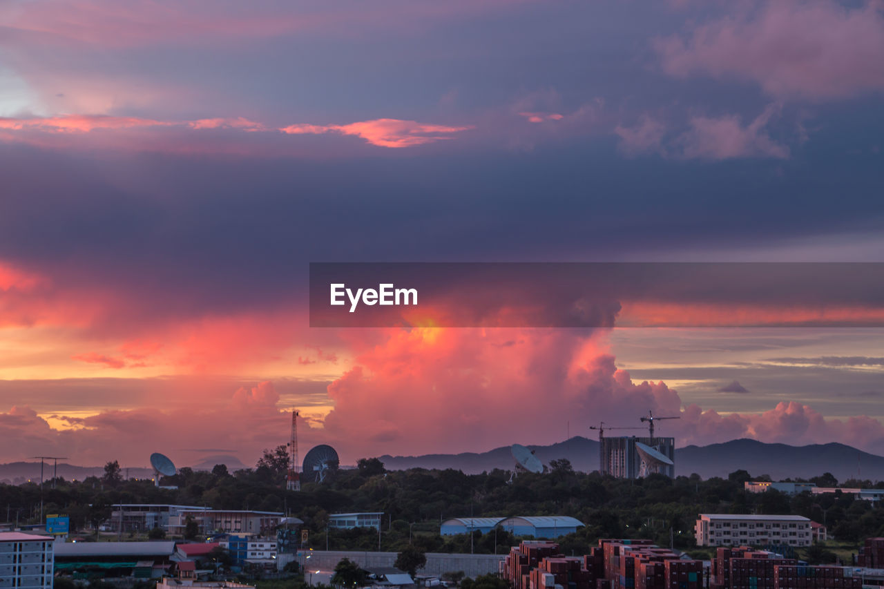 BUILDINGS IN CITY AGAINST DRAMATIC SKY