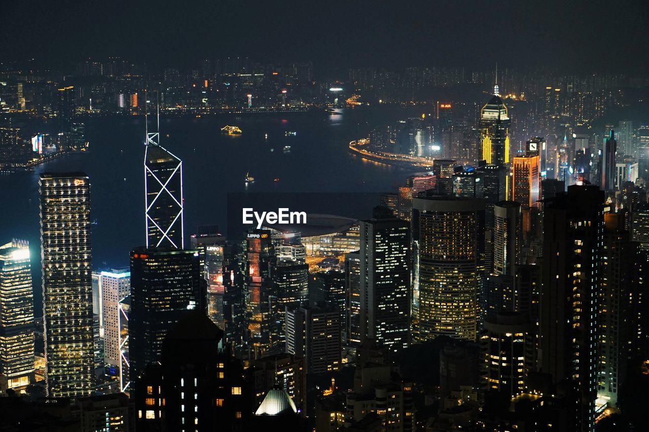 High angle view of illuminated buildings in city at night