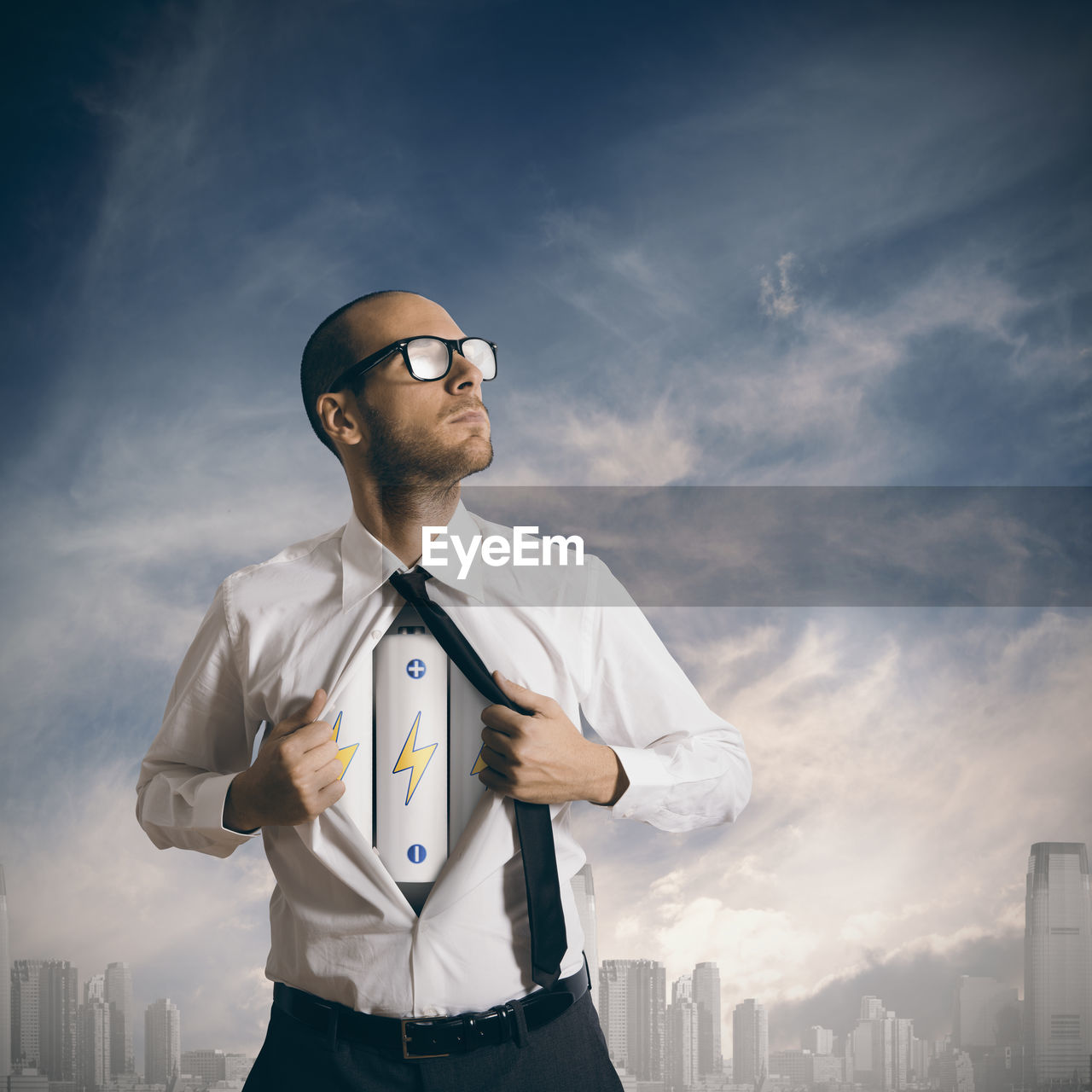 YOUNG MAN STANDING AGAINST SKY